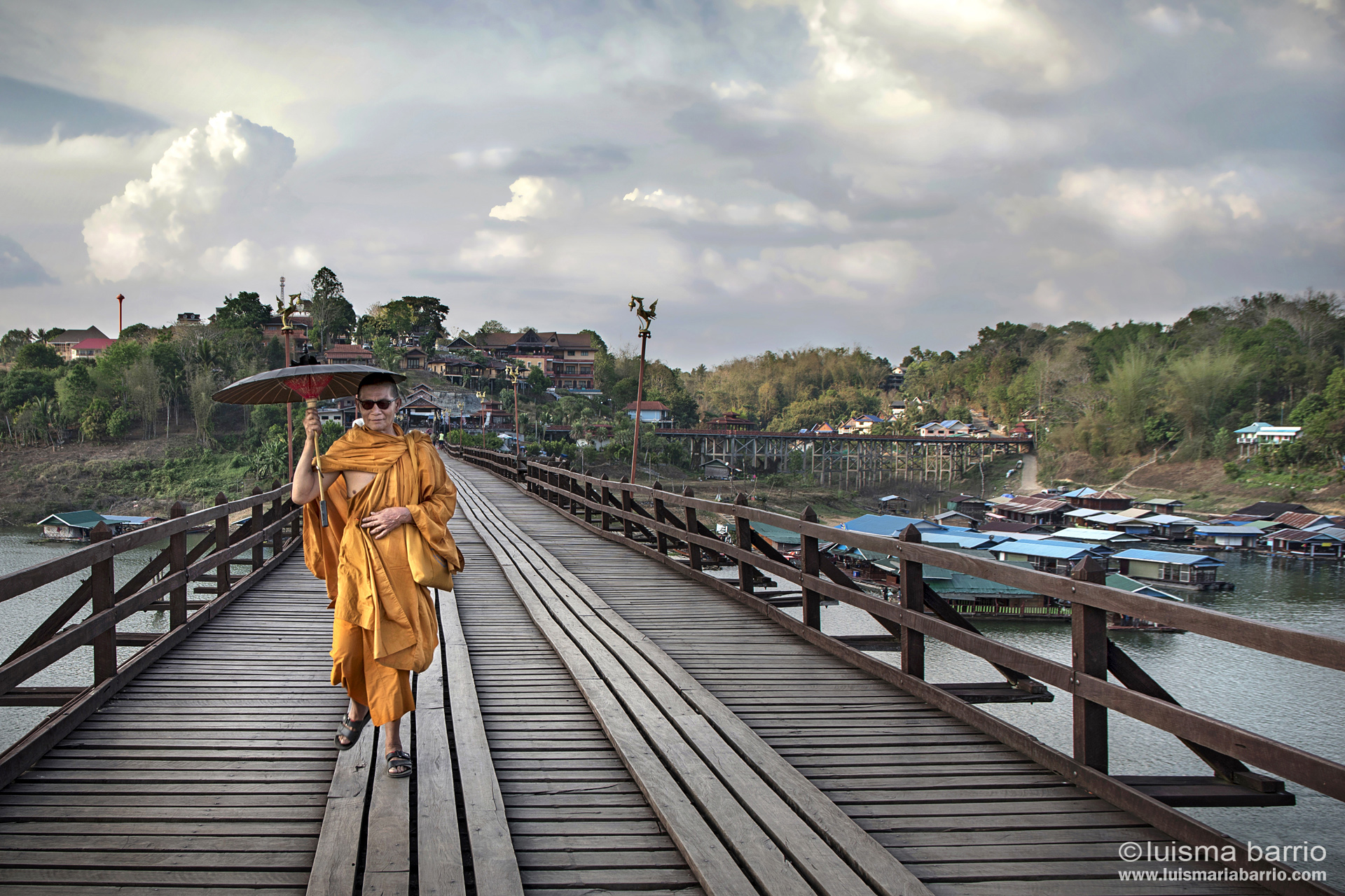 Monk on wooden bridge